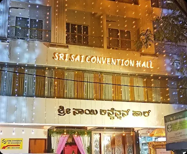 Hall signage in English and Kannada, lit at night